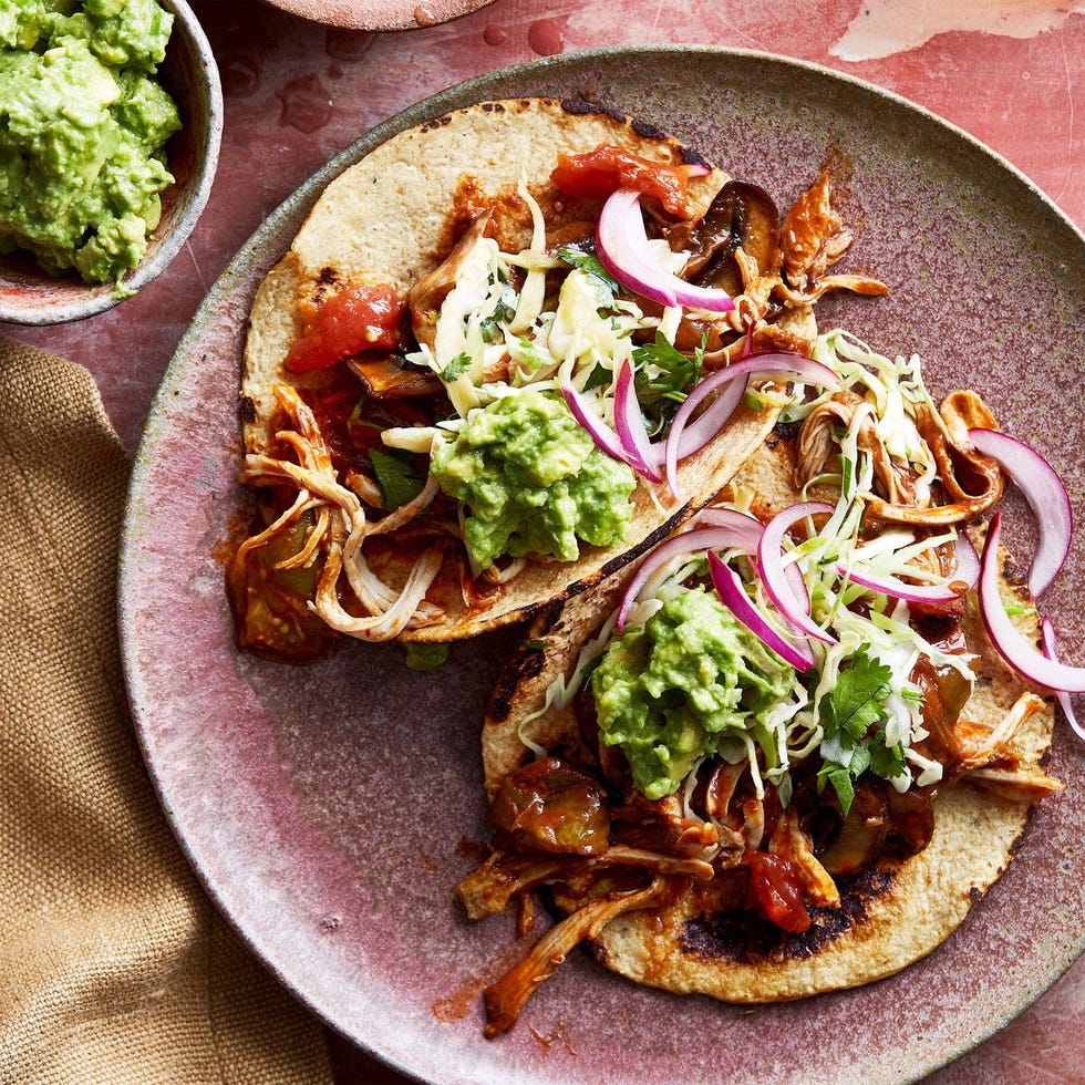 chicken mole tacos with guacamole on top
