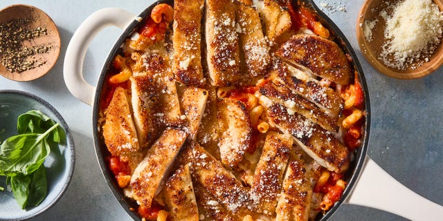 red sauce pasta topped with cheese and sliced chicken breast
