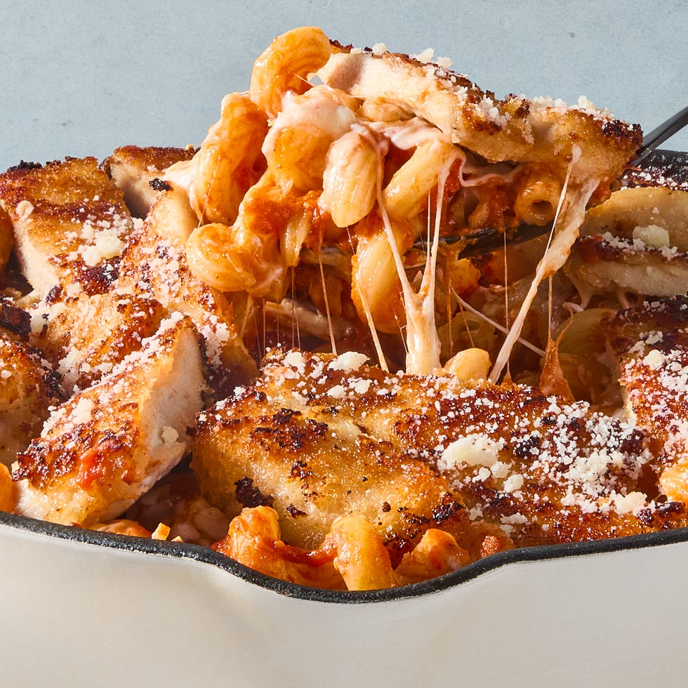 red sauce pasta topped with cheese and sliced chicken breast