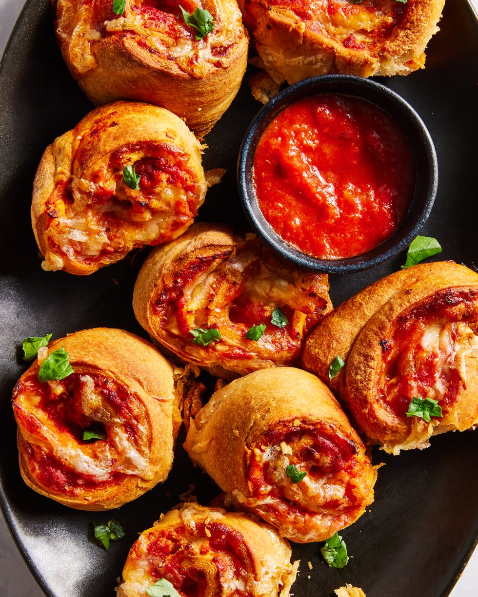 chicken parm pinwheels on a platter with marinara sauce
