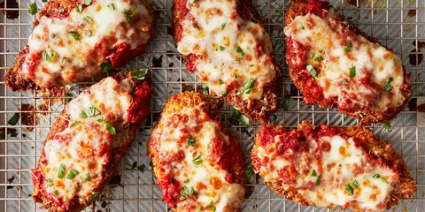 chicken parmesan with melted cheese and fresh herbs