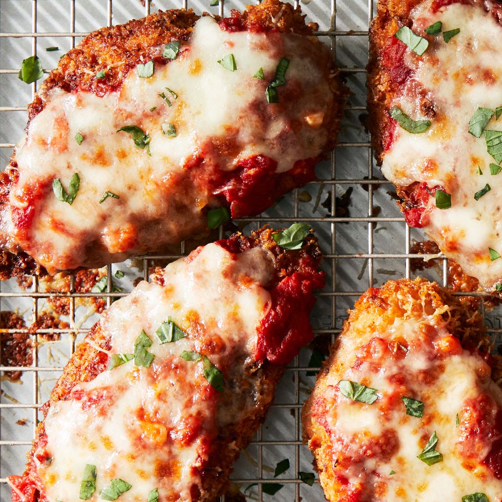 chicken parmesan covered with melty cheese and fresh herbs