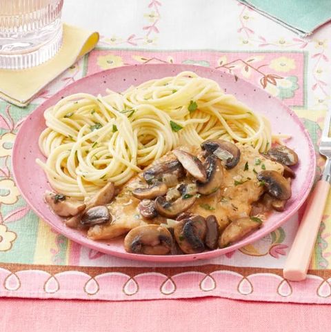 chicken marsala with butter parsley noodles on pink plate