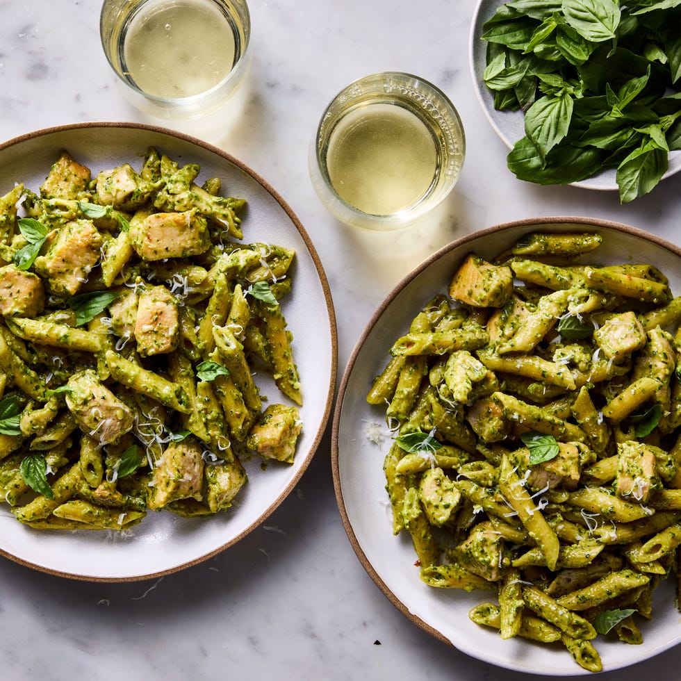 chicken pesto pasta topped with basil and parmesan cheese