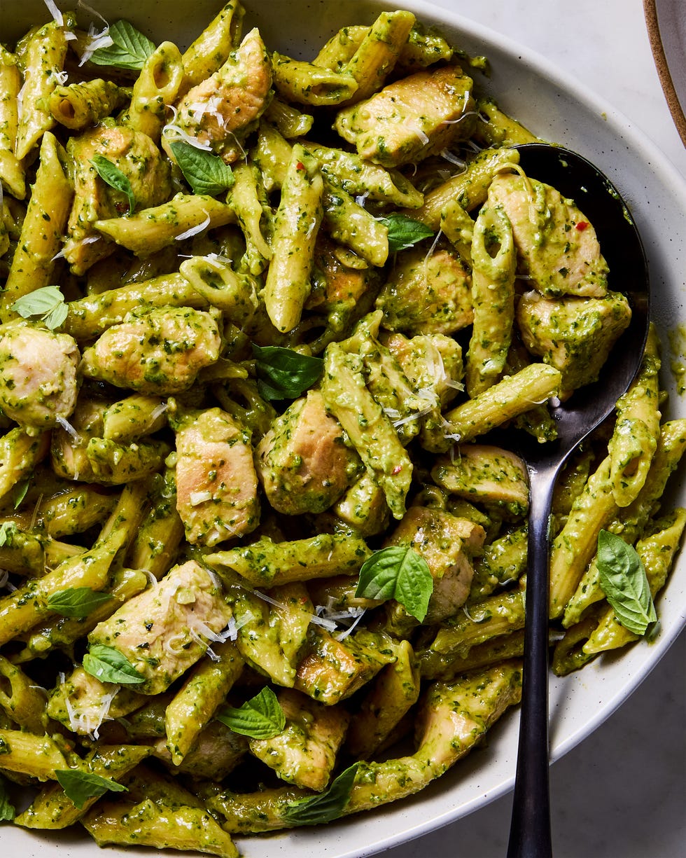 chicken pesto pasta topped with basil and parm