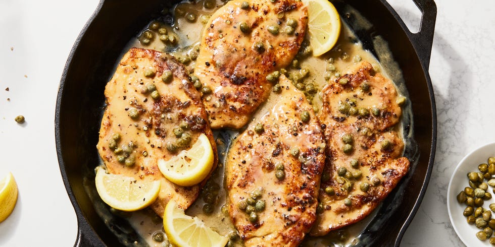 chicken piccata in a skillet with lemon butter caper sauce