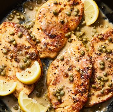 chicken piccata in a skillet with lemon butter caper sauce