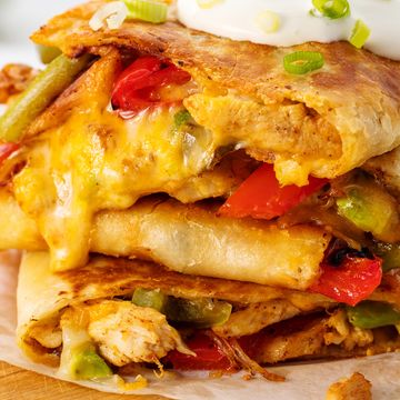 chicken and cheese and peppers in a crispy tortilla