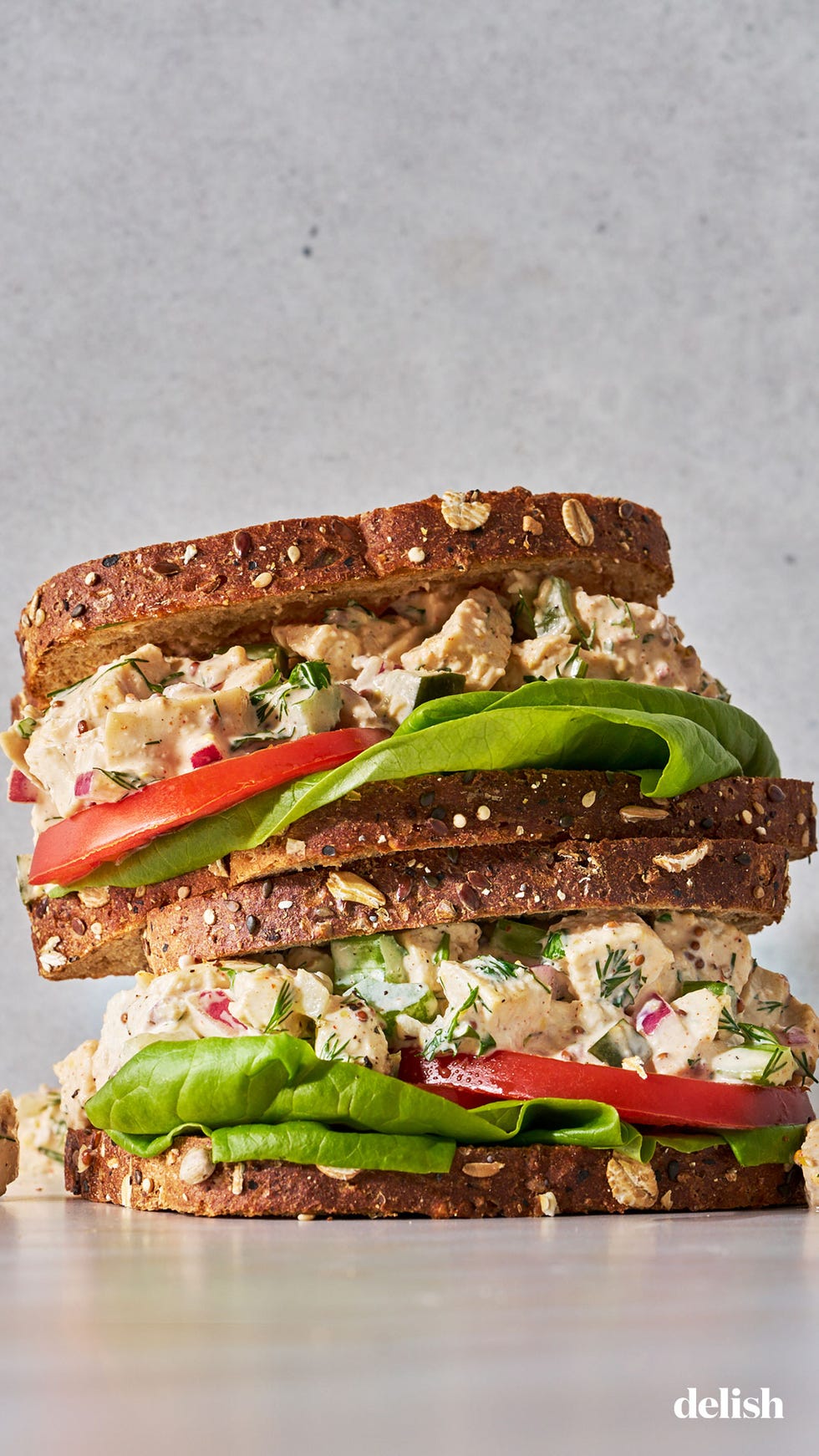 poached chopped chicken tossed with onion, dill, celery, mayo, and greek yogurt with lettuce and tomato on whole grain bread