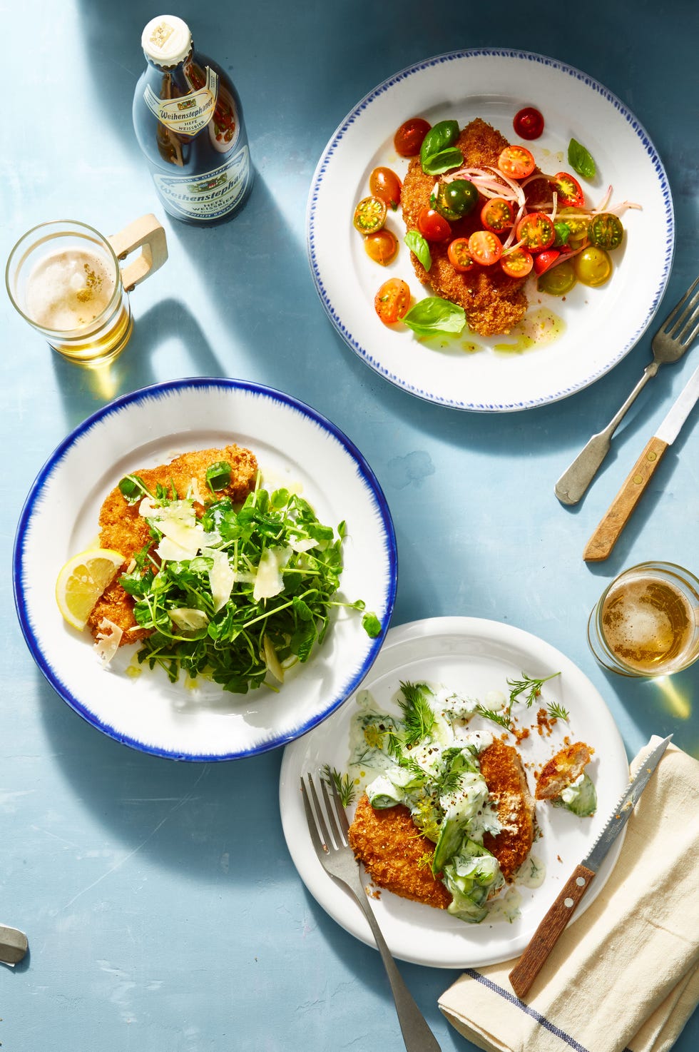 a plate of chicken schnitzel with a side of salad