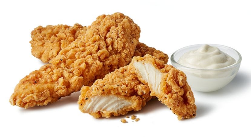 fried chicken tenders served with a side of dipping sauce