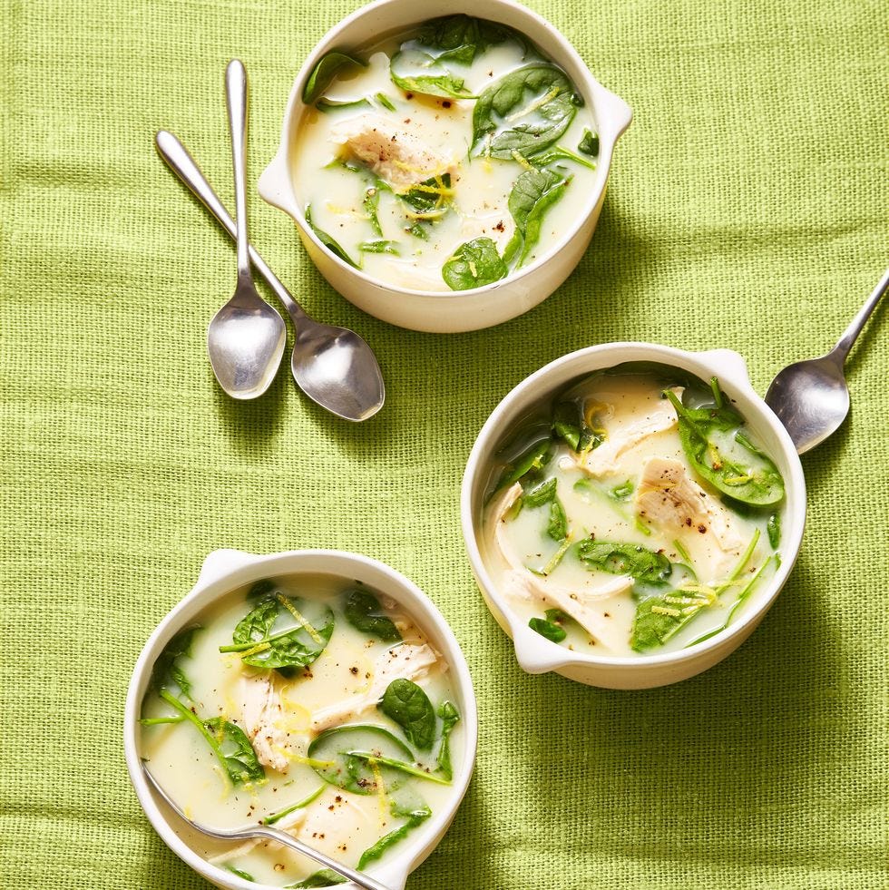 chicken soup with spinach and lemon on green cloth