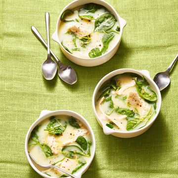 greek lemon and spinach soup in white bowls