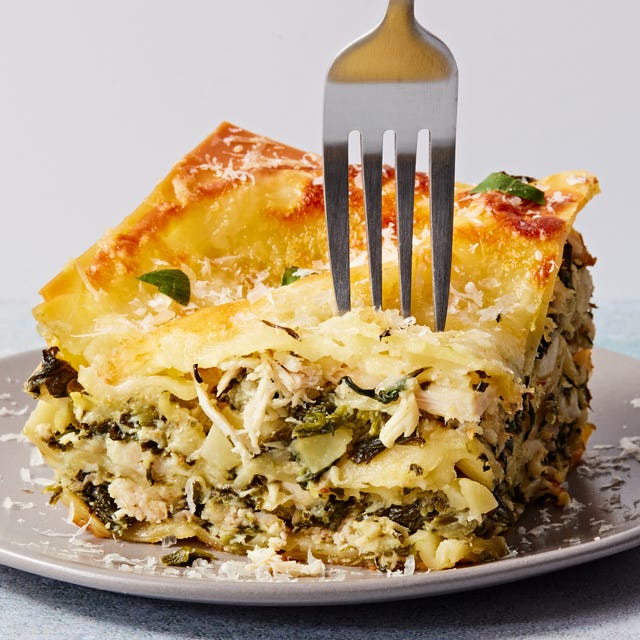cheesy lasagna with layers of spinach and artichoke