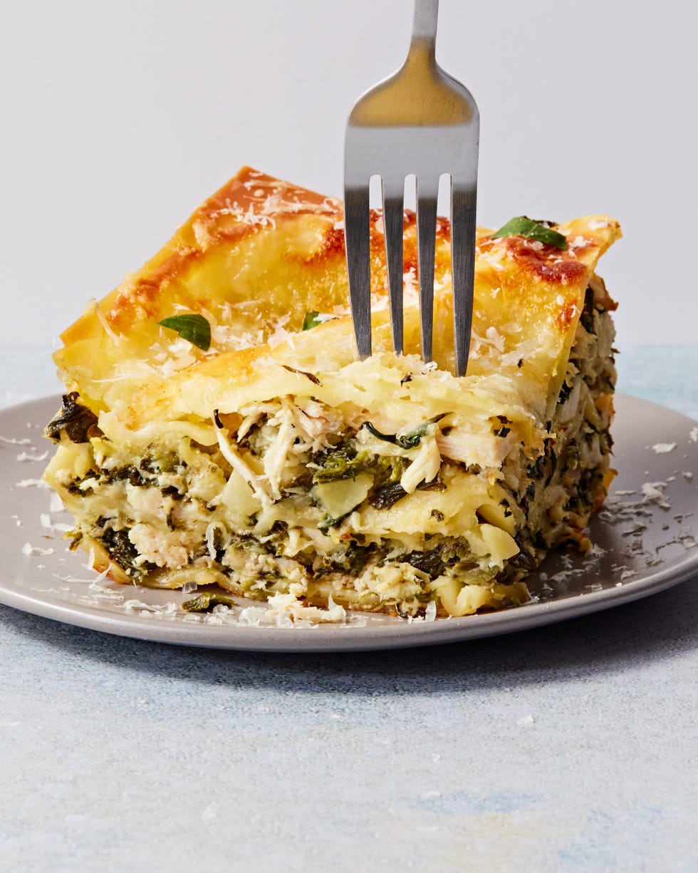cheesy lasagna with layers of spinach and artichoke