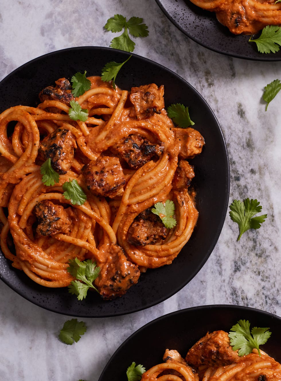 bucatini pasta in a creamy tikka masala sauce and chicken