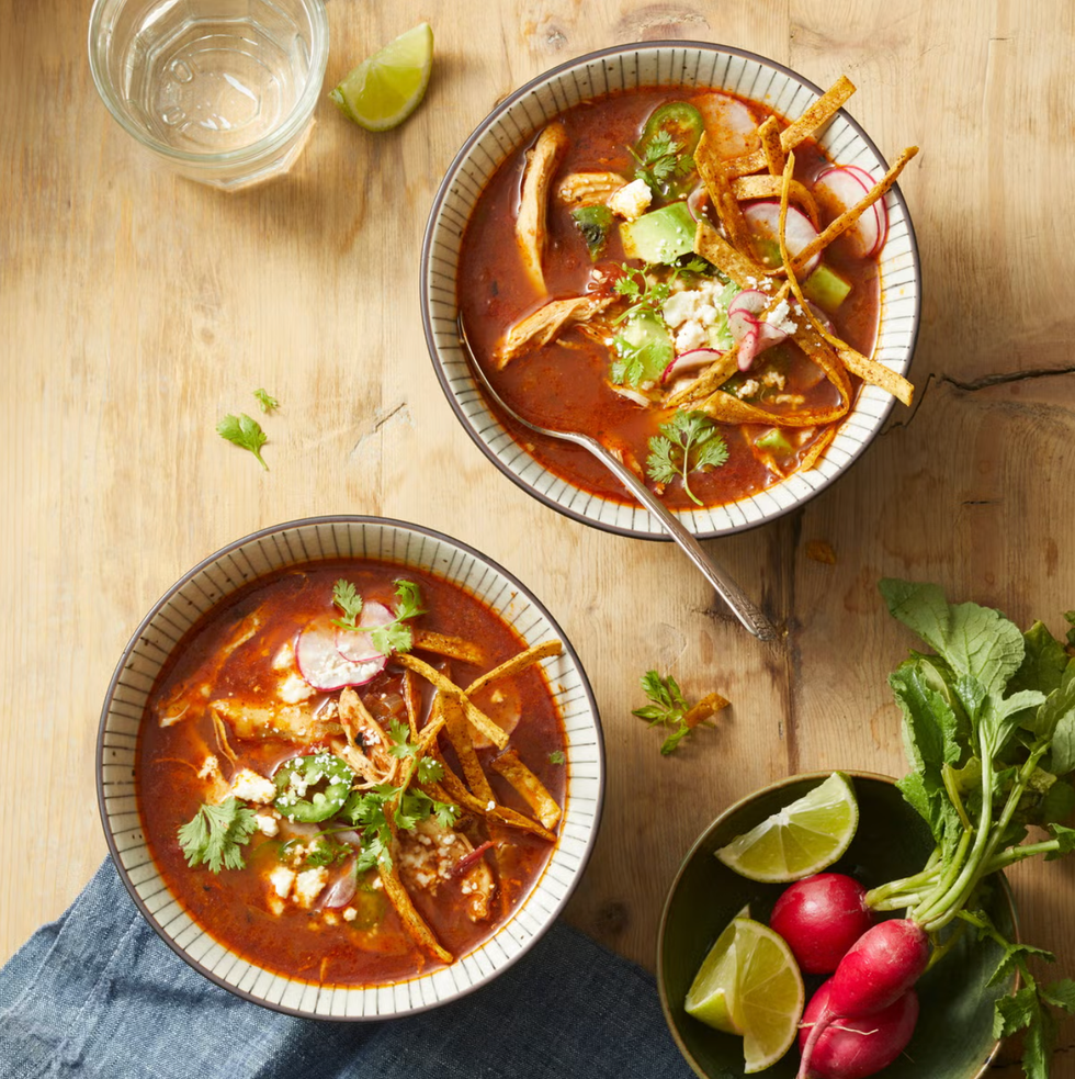 chicken tortilla soup with cilantro and tortilla strips on top