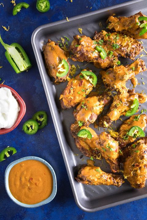jalapeno cheddar chicken wings on baking sheet with dips