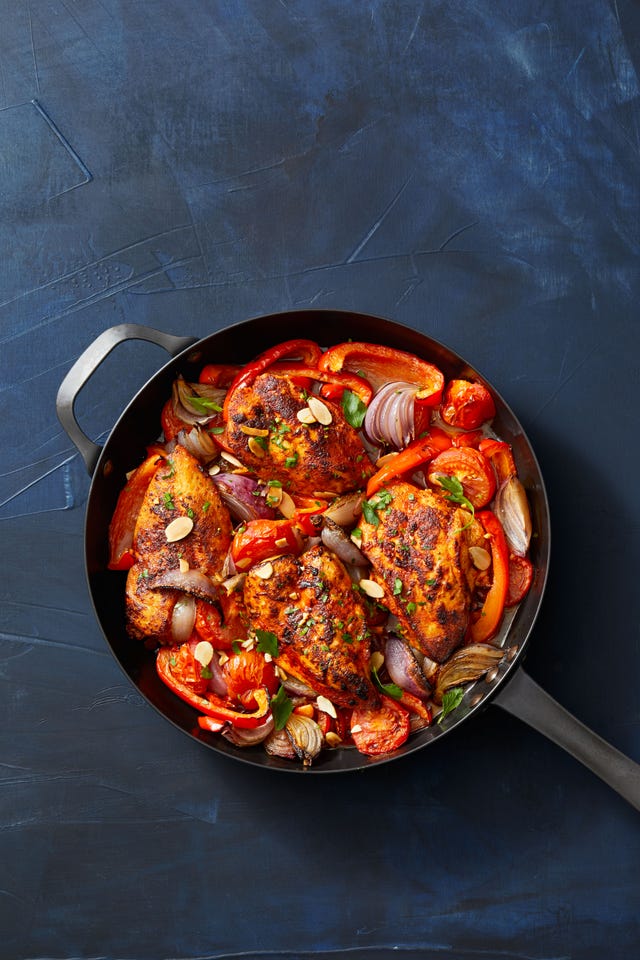 chicken with stewed peppers in skillet