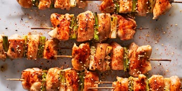 chicken on a skewer with scallions and seasoning