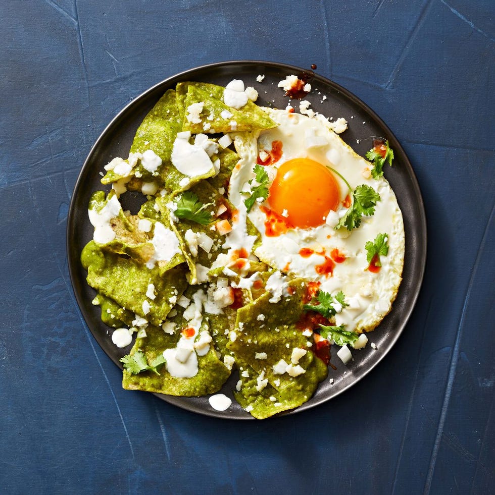 chilaquiles with green salsa and an over easy egg on the side