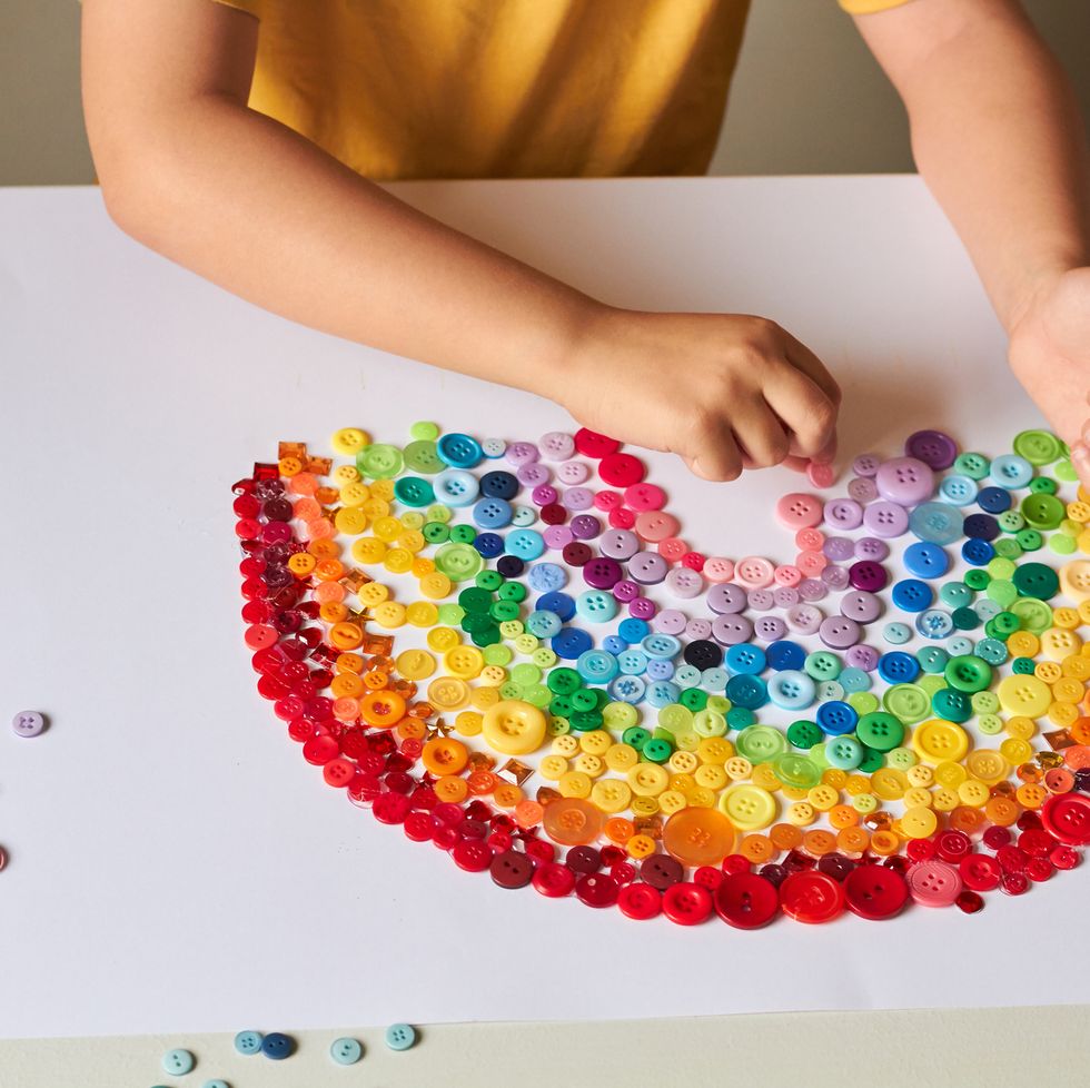 A child makes a beautiful rainbow using craft materials