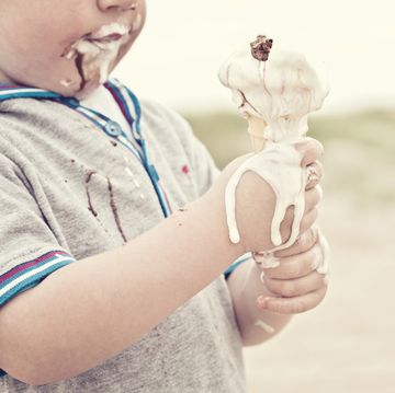 child eating melted ice cream