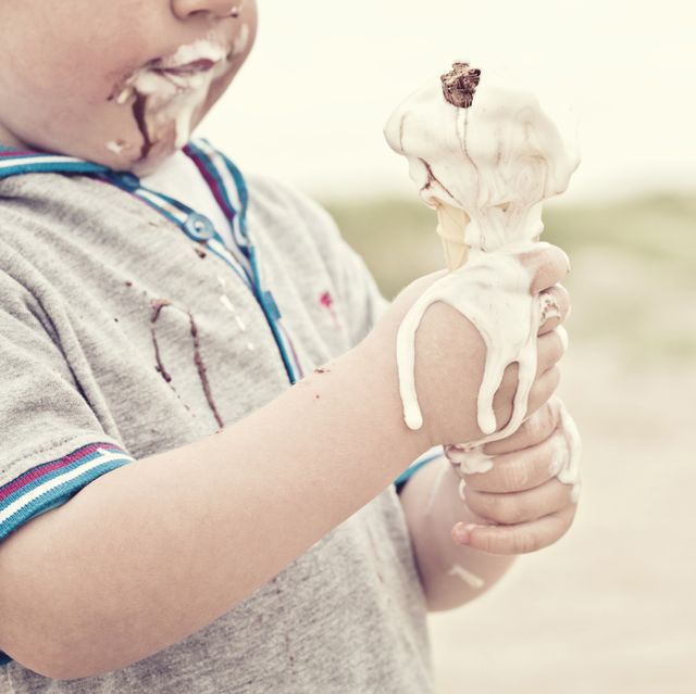 child eating melted ice cream