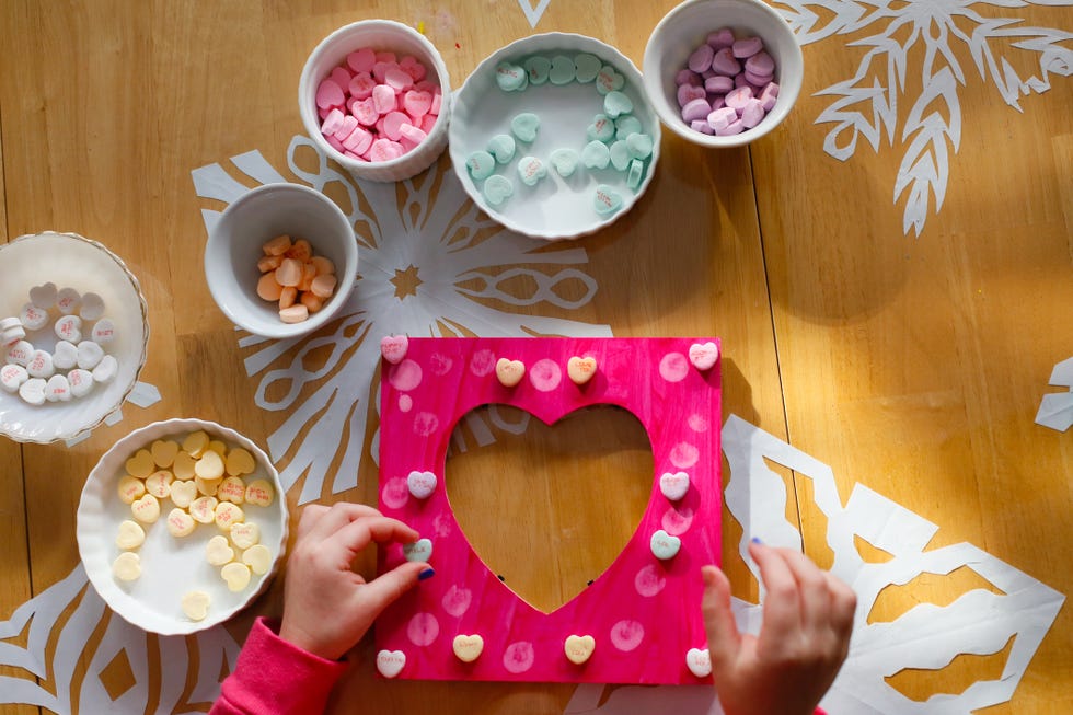 a child making a picture frame for valentine's day