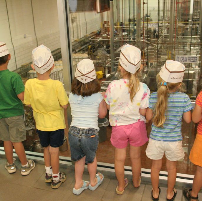 children at a ice cream making plant, blue bell creameries the blue bell creamery factory tour is a good housekeeping pick for best factory tours