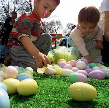 children gather colored eggs stuffed with candy during the 5