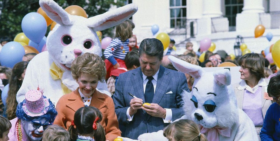 a person standing in front of a group of people wearing bunny ears