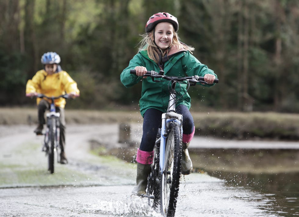 children ringing over ford on bikes