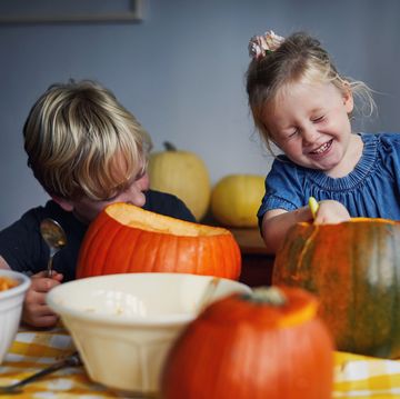children scooping out pumpkins