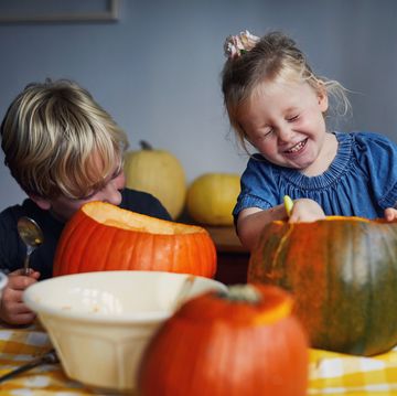 children scooping out pumpkins