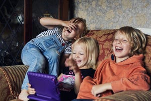 kids looking at a tablet and laughing at jokes for kids