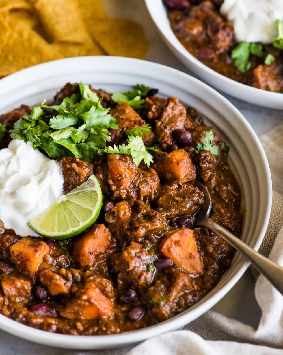 chipotle sweet potato pork chili with sour cream and lime