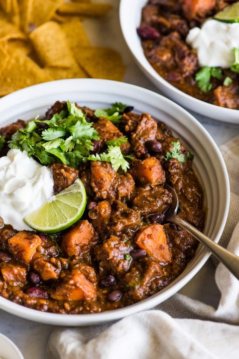 chipotle sweet potato pork chili with sour cream and lime