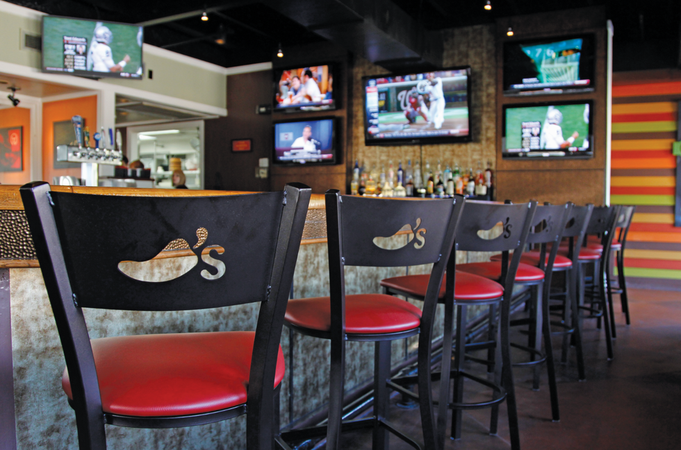 a bar with a table and chairs