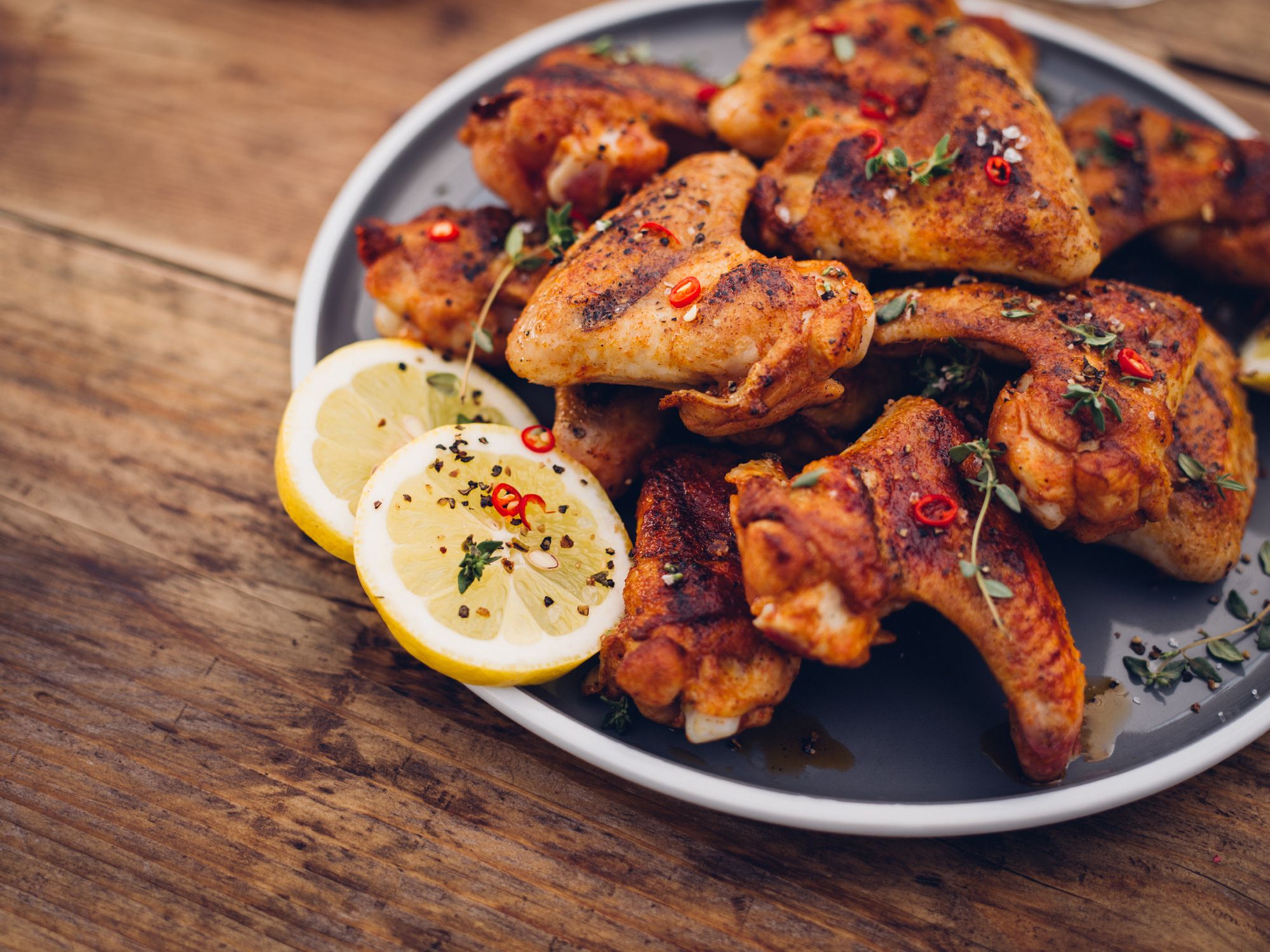 https://hips.hearstapps.com/hmg-prod/images/chillie-sprinkled-spicy-chicken-wings-on-a-wooden-royalty-free-image-484806894-1554131875.jpg