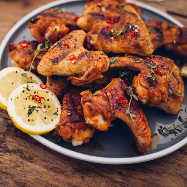 Chillie sprinkled spicy chicken wings on a wooden table