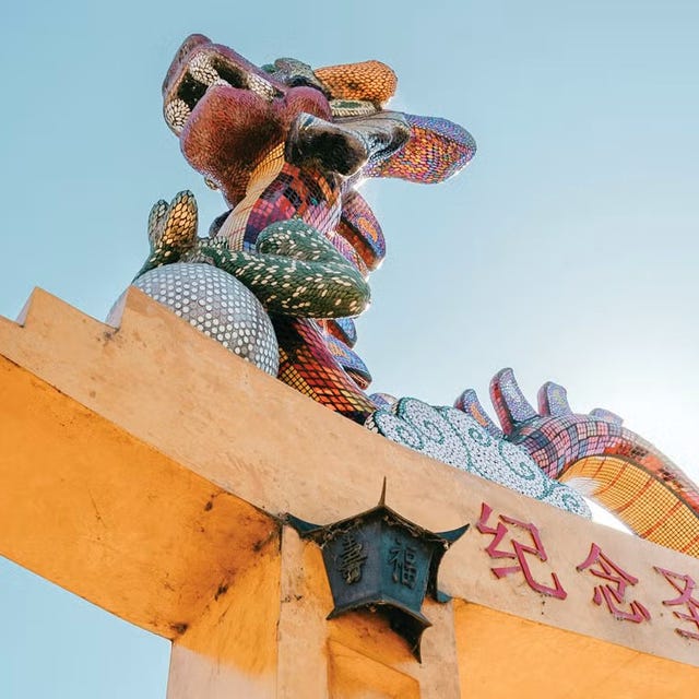 colorful dragon sculpture on top of an archway colorful dragon sculpture on top of an archway