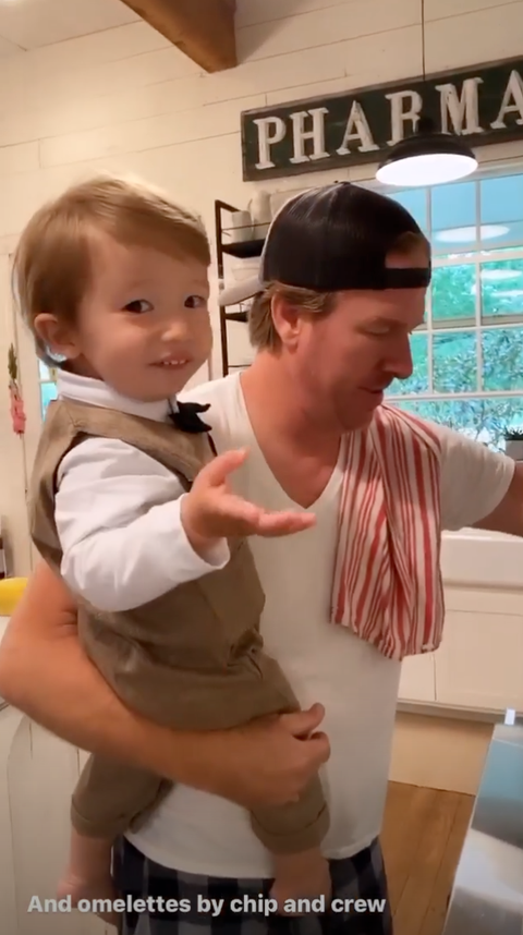 chip gaines holding crew gaines while cooking breakfast for joanna