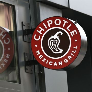 a round chipotle restaurant sign outdoors