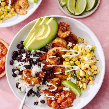 Chipotle Shrimp Taco Bowls chipotle shrimp with black beans, corn salsa, salsa, and avocado in a rice bowl