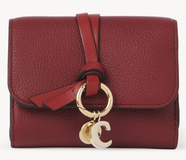 a red purse with a gold ring