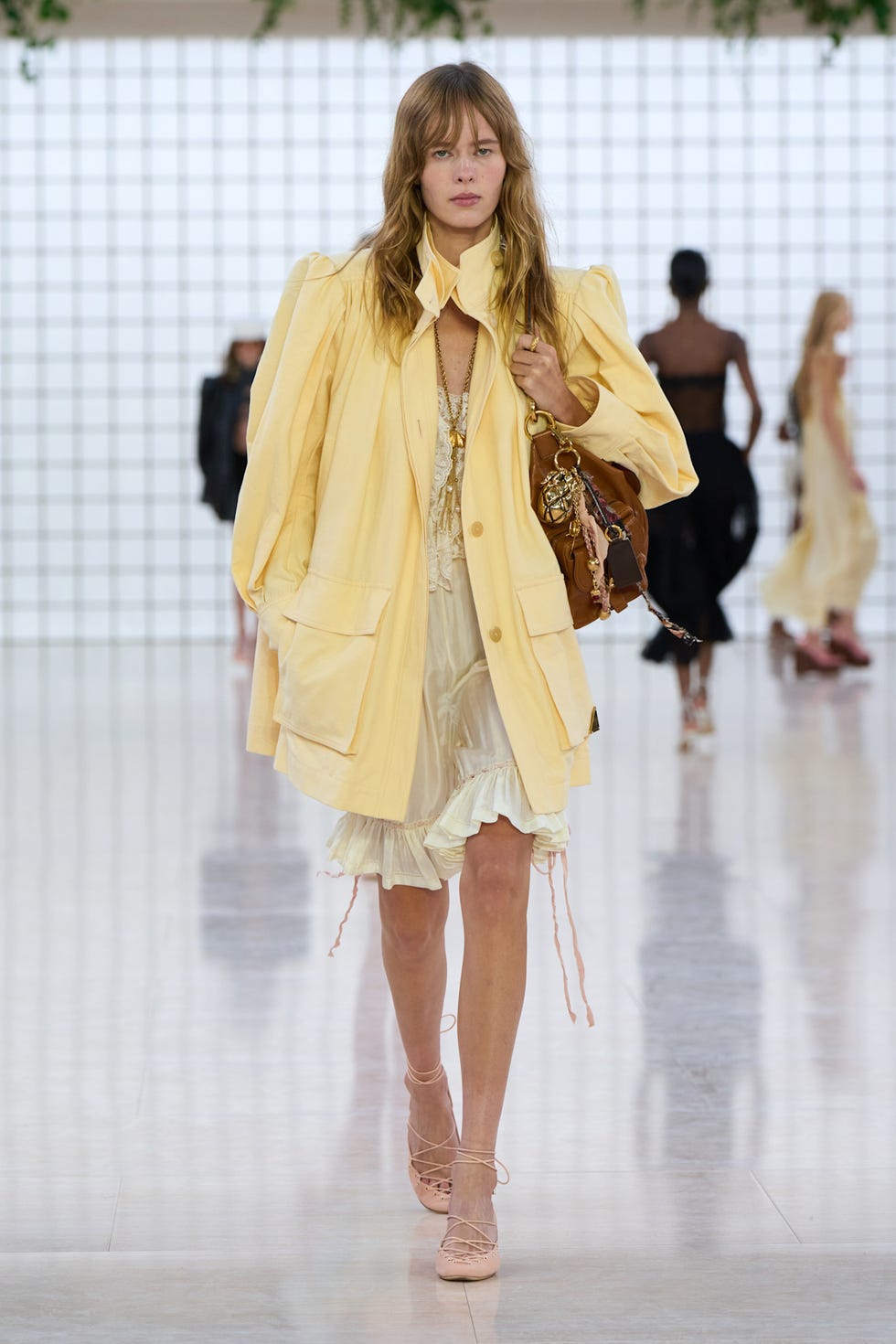 model wearing butter yellow jacket over white dress