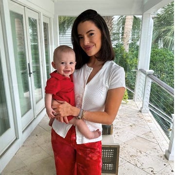 woman holding a child in a bright interior space woman holding a child in a bright interior space