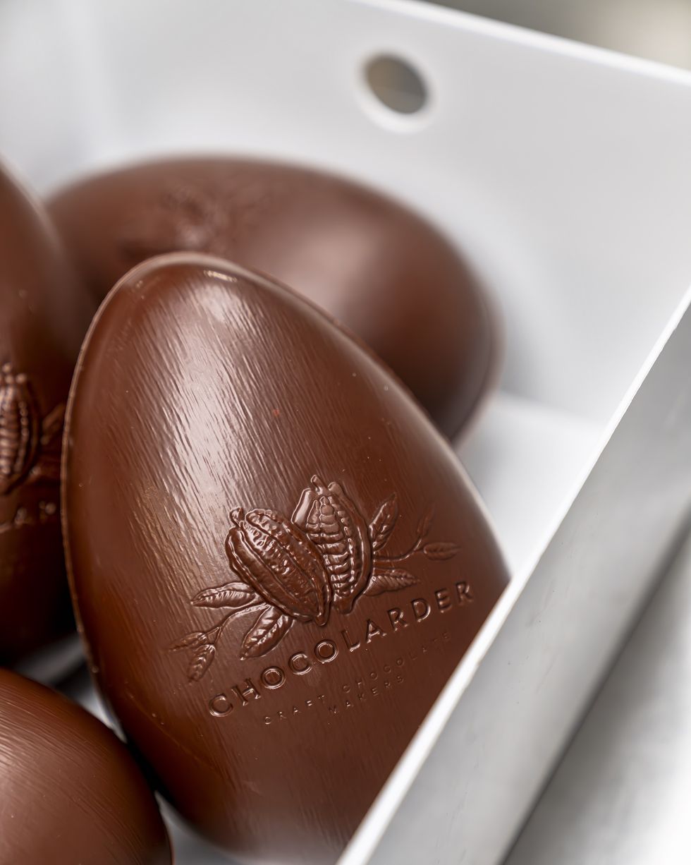 a chocolate easter egg with the chocolarder logo