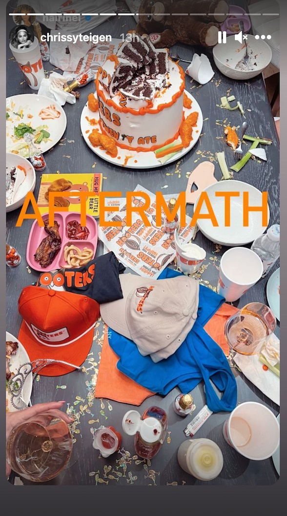 messy table with hooters merch, eaten cake, rogue wings